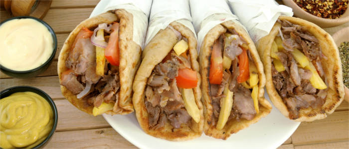 Delicious souvlaki with tomatoes, onions and chips